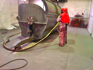 Shot blasting a dung spreader prior to priming and painting at Marshall trailers