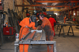 Hand welding silage sides - now done by robots.